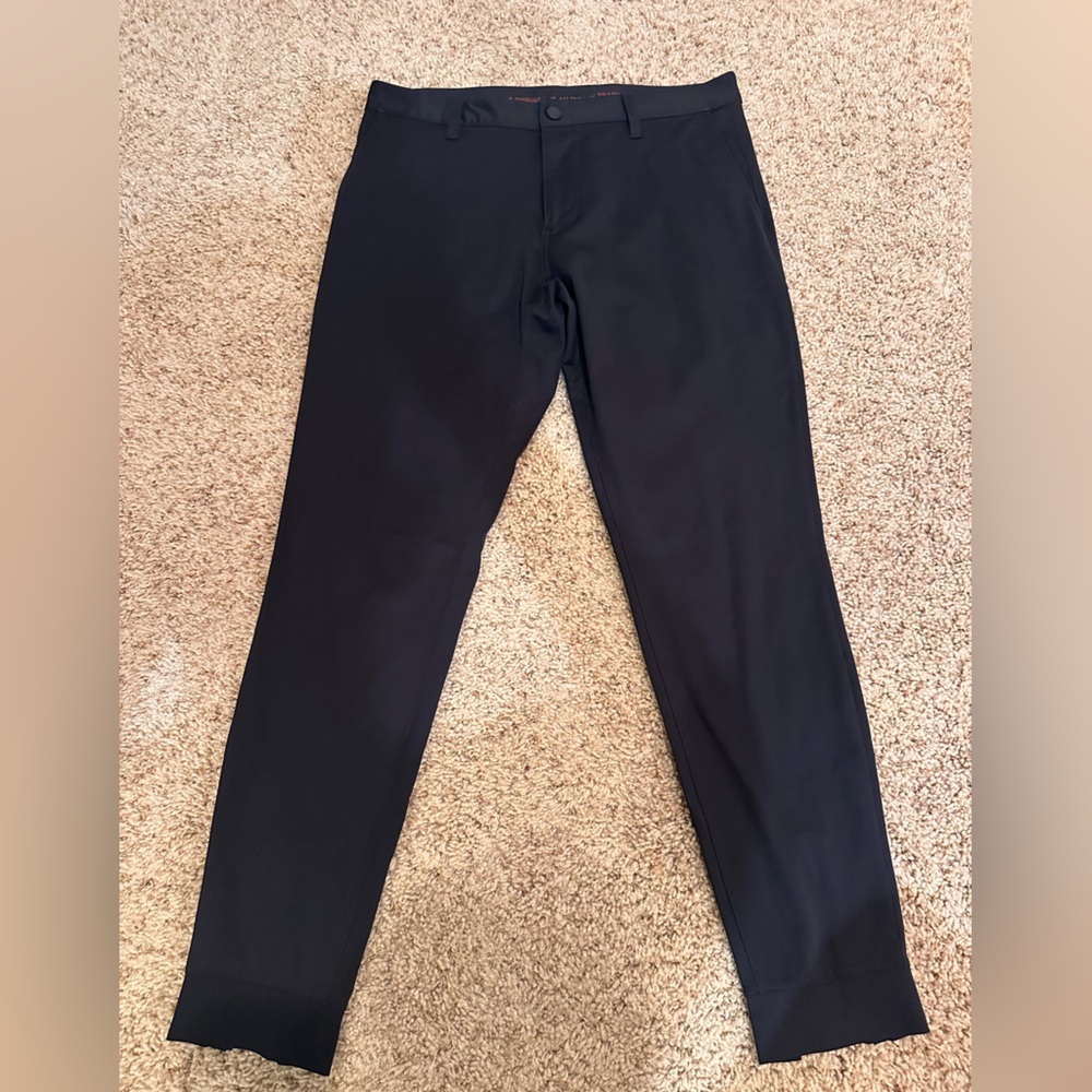 Rhône Men’s Tech Trouser
Size 31, Skinny fit 
Black